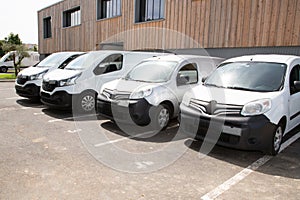 Delivery vans ready to leave to deliver the parcels, park in front of the head office