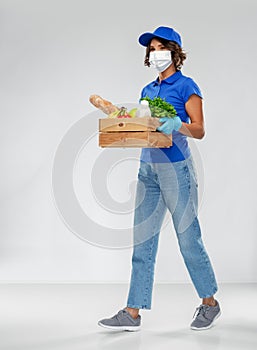 Delivery woman in face mask with food in box