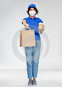 Delivery woman in face mask with food and drinks