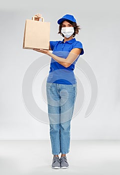 Delivery woman in face mask with food in paper bag