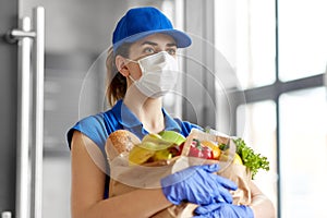 Delivery woman in face mask with food in paper bag