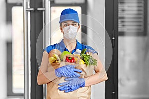 Delivery woman in face mask with food in paper bag