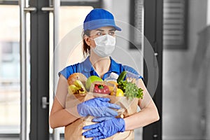Delivery woman in face mask with food in paper bag