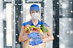 Delivery woman in face mask with food in paper bag