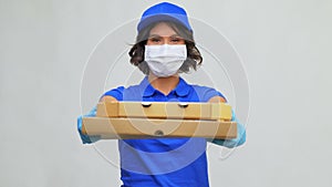 Delivery woman in face mask with pizza boxes