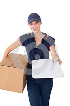 Delivery woman holding cardboard box and clipboard