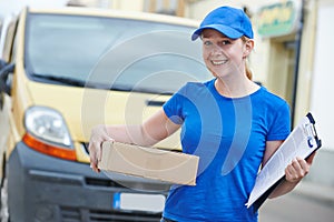 Delivery woman with package outdoors