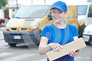 delivery woman with package outdoors. Shipping services