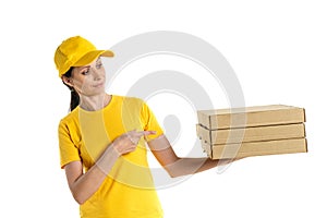 Delivery woman with pizza in cardboard boxes on background