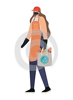 delivery woman with safety mask and one ecobag full of market products