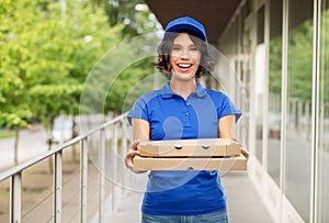 Delivery woman with takeaway pizza boxes