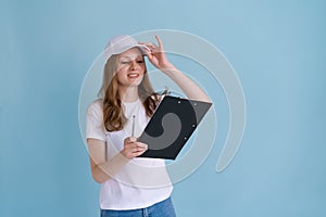 Delivery woman in white uniform isolated on blue background. Girl in white cap