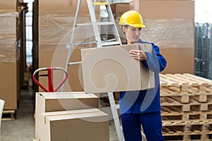 Delivery worker unloading cardboard boxes from pallet jack