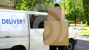Delivery workman holding many cardboard boxes, express parcel shipment service