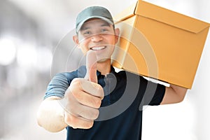 Deliveryman carrying a box, giving thumbs up
