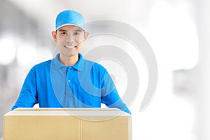 Deliveryman carrying a cardboard parcel box