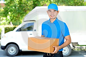 Deliveryman carrying a cardboard parcel box