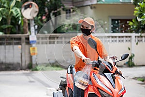 deliveryman with face mask on bike wait for customer
