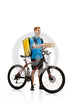 Deliveryman isolated on white studio background. Contacless delivery service during quarantine.