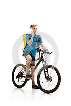 Deliveryman isolated on white studio background. Contacless delivery service during quarantine.