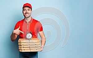 Deliveryman is punctual to deliver quickly pizzas. Cyan background