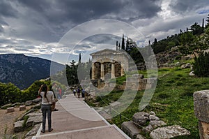 Delphi Town, Phocis / Greece - October 22, 2012: Tourists are following the Sacred Way at the famous archaeological site of Delphi