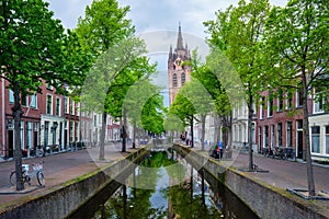 Delt canal with bicycles and cars parked along. Delft, Netherlands