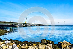 The Delta Works Storm Surge Barrier and Wind Turbines at the Oosterschelde viewed from Neeltje Jans island