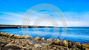 The Delta Works Storm Surge Barrier and Wind Turbines at the Oosterschelde viewed from Neeltje Jans island