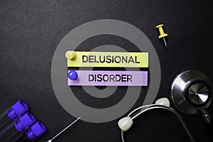 Delusional Disorder text on Sticky Notes. Top view isolated on black background. Healthcare/Medical concept photo
