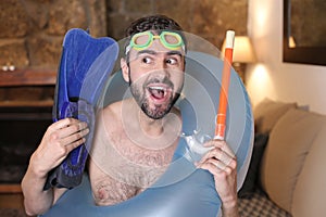 Delusional man with snorkeling gear in living room
