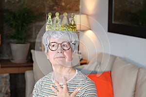 Delusional senior lady wearing a crown