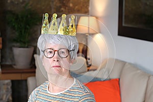 Delusional senior lady wearing a crown photo