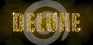 DELUXE. Letters  from a floral ornament with golden glitter and sparks on a dark background with bokeh.