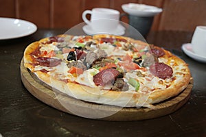 Deluxe Pizza with Pepperoni, Sausage, Mushrooms and Peppers