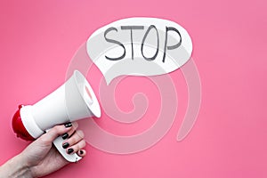 Demand to stop concept. Megaphone near cloud with word stop on pink background top view space for text