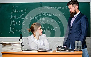 Demanding lecturer. Teacher strict serious bearded man having conflict with student girl. Man unhappy communicating