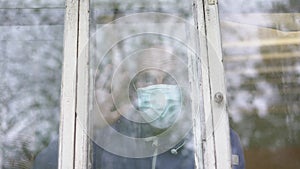 Demented aged man in face mask waving greeting gesture with hand