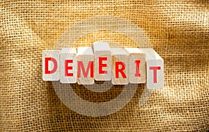 Demerit symbol. The concept word Demerit on wooden blocks. Beautiful canvas background, copy space. Business and demerit concept