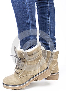 demi-season, women`s shoes, beige, on the feet in jeans, white background, laces