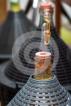Demijohn with glass fermentation lock.