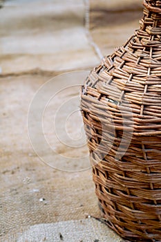 Demijohn and old wood wine barrel on jute sack