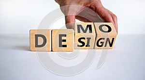 Demo and design symbol. Businessman hand turns cubes and changes the word `design` to `demo`. Beautiful white background. Busi