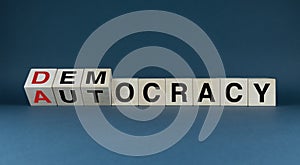 Democracy or Autocracy. The cubes form the words Democracy or Autocracyr