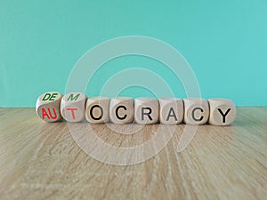 Democracy or autocracy symbol. Turned wooden cubes