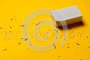 Democracy and an eraser on a yellow background. The disappearance of democracy concept