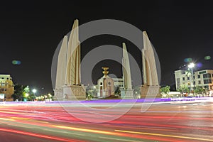 Democracy monument is circular traffic landmark at Bangkok Thailand . architecture in history . slow motion of light on street at