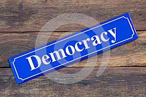 Democracy street sign on wooden background