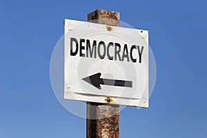 Democracy word and arrow signpost