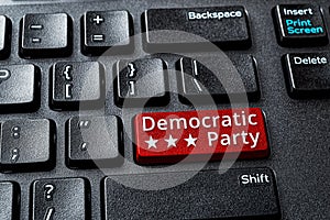 Democratic Party red key on a decktop computer keyboard. Concept of voting online for Democratic party, politics, United States photo